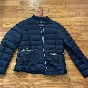 Lightweight navy blue puffer jacket with ruffles